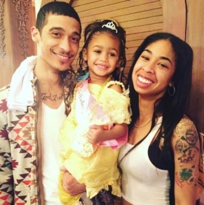 Amarah Dean posing with her husband, Chris, and daughter, Charlie Rose